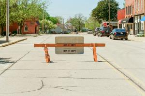 city street blocked by barrier on sunny day