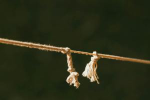 close up of frayed rope on green background