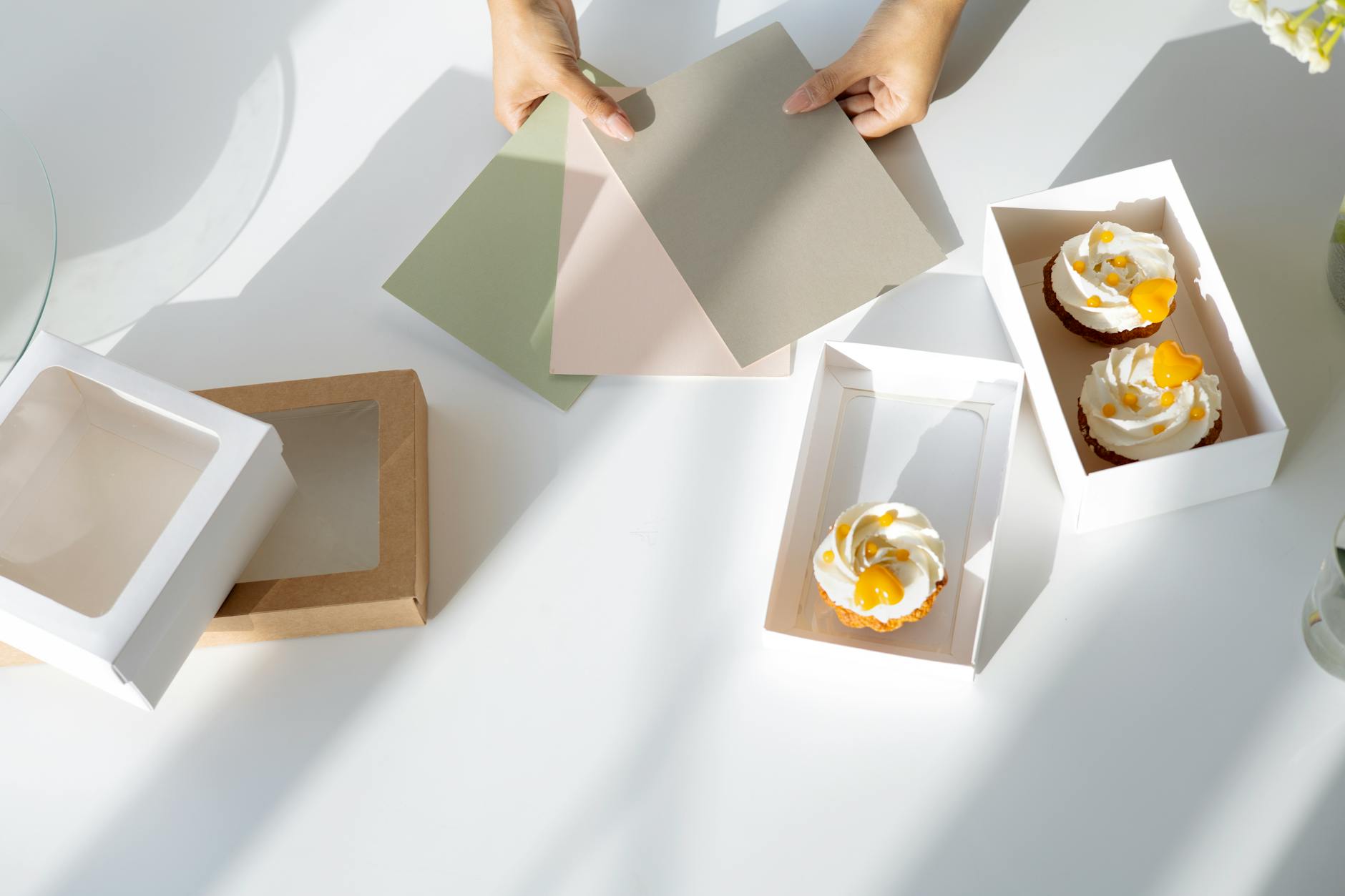 person holding white and brown box