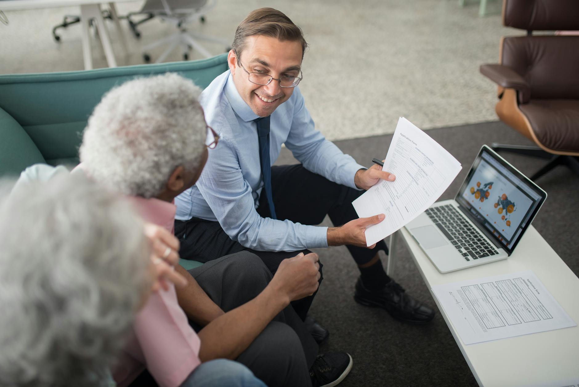 an agent showing documents to an elderly man